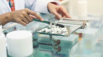pharmacists organizing pills - Ohio Pharmacies’ Role In The Opioid Epidemic