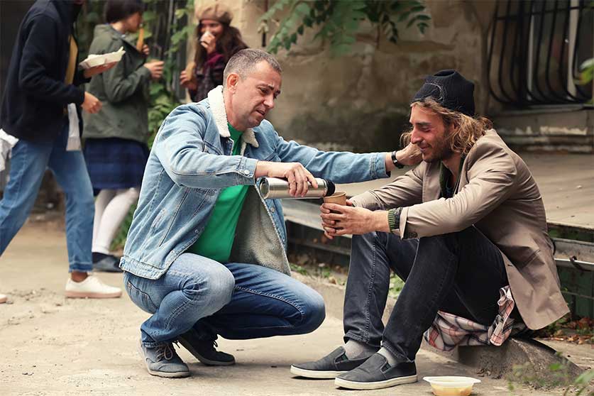 Man Giving A Homeless Person Coffee-10 Random Acts Of Kindness For Better Mental Health
