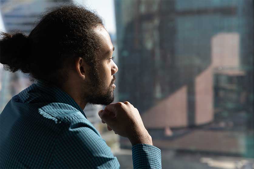 Man Looking Out Window-Is Addiction Hereditary Or Genetic?