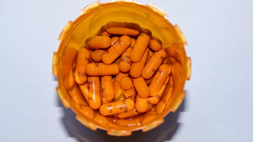 image of bottle of orange adderall pill capsules - Adderall Dosage Guide