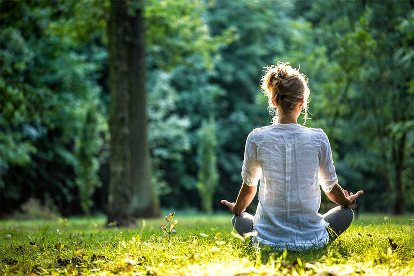 Woman Doing Yoga In The Woods-7 Of The Best Exercises To Boost Your Mental Health